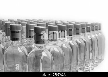 Flacons d'alcool pur non étiquetés. Une multitude de bouteilles de boissons alcoolisées maison isolées sur blanc. Production de petites liqueurs basée sur la distillation. B Banque D'Images