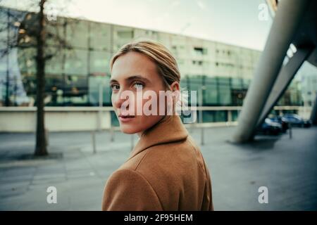 Belle femme d'affaires caucasienne avec les yeux bleus marchant au travail Banque D'Images