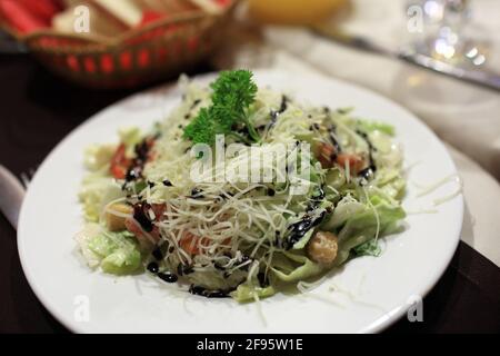 Salade de fruits de mer, fromage et légumes sur une assiette blanche Banque D'Images