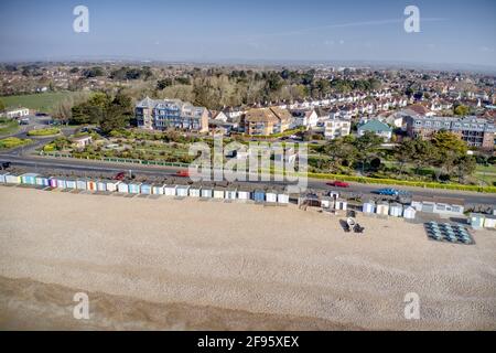 Une rangée de cabanes de plage aux couleurs vives à Bognor Regis avec les jardins du parc marin en arrière-plan. Vue aérienne. Banque D'Images
