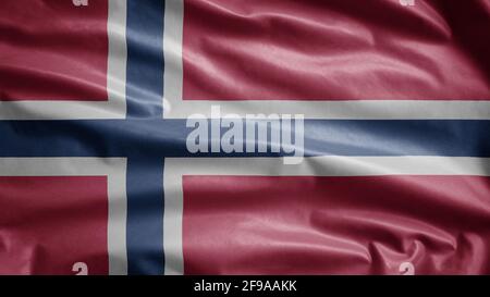 Drapeau norvégien agitant dans le vent. Gros plan de la bannière norvégienne en soie douce et lisse. Tissu texture ensign arrière-plan. Banque D'Images