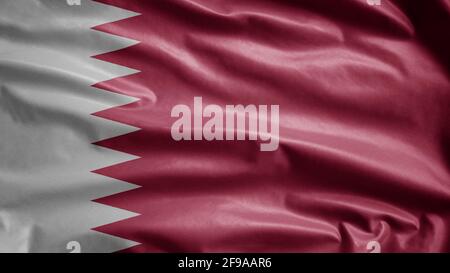 Drapeau qatari agitant dans le vent. Gros plan sur la bannière Qatar, soie douce et lisse. Tissu texture ensign arrière-plan. Banque D'Images