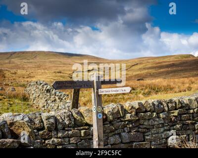 De vieilles enseignes en bois et un mur en pierre sèche pointent vers le chemin au-dessus des montagnes. Réservoir de la maison de cicatrice. Niddoyre. Yorkshire Dales Banque D'Images