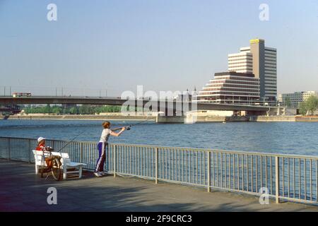 Garçon pêchant dans le Rhin en 1981 avec Deutz Bridge et ancien bâtiment Lufthansa en arrière-plan, Cologne, Rhénanie-du-Nord-Westphalie, Allemagne Banque D'Images