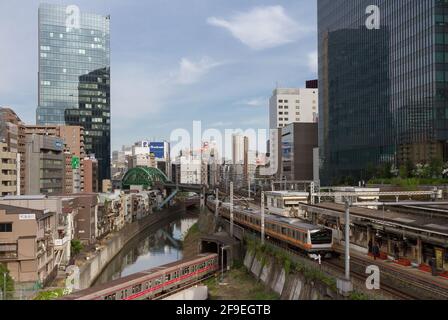 Un train de la série 02 du métro de Tokyo sur la ligne Marunouchi passe sous un train de la série E233 sur la ligne Chuo à la gare Ochanomizu, Tokyo, Japon. Banque D'Images