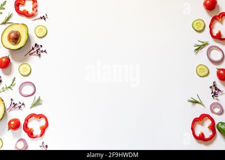 Mise en page créative de tomates, concombres, poivrons, avocats et salades. plat. Concept alimentaire. Place pour votre texte. Banque D'Images