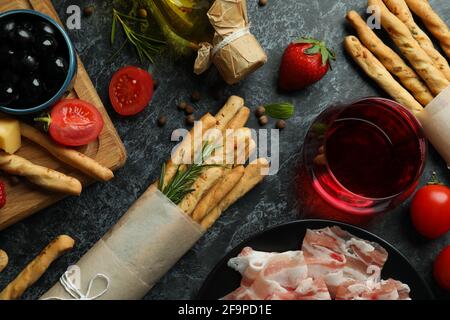 Bâtonnets de Grissini, en-cas et vin sur fond noir fumé Banque D'Images