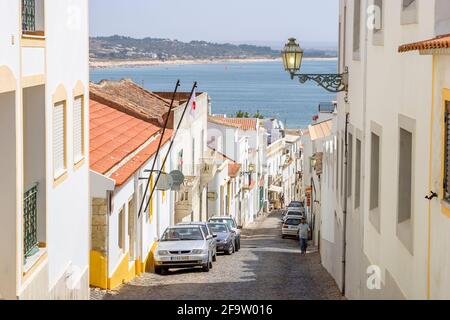 Rue escarpée menant à la côte de Lagos, une ville historique et une destination touristique populaire dans l'Algarve, au sud-ouest du Portugal, en été Banque D'Images