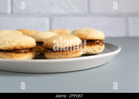Biscuits Alfahores au lait condensé sur une assiette grise biscuits traditionnels faits maison. Concept de cuisine maison. Orientation horizontale. Gros plan. Banque D'Images