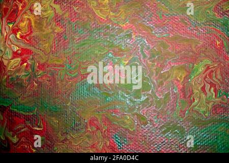 Toile d'image marbrée avec peinture acrylique dans les couleurs rouge, vert et jaune. Banque D'Images