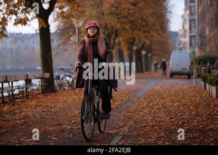 Copenhague, Danemark 12 octobre 2017. Femme à vélo dans un casque. Les gens à Copenhague, Danemark style de vie et culture. Banque D'Images