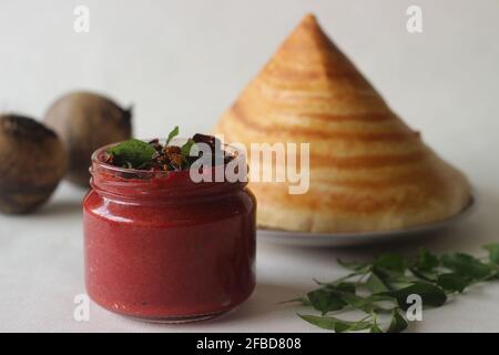 Condiment frais, épicé et sucré fait maison avec des betteraves, des piments, des échalotes de noix de coco et des épices. Tourné avec une crêpe croustillante faite de riz et de lentilles Banque D'Images