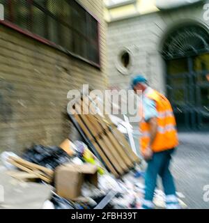 Employé du service municipal de nettoyage au travail dans une rue sale, Naples, Italie Banque D'Images