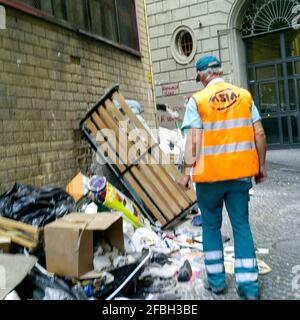 Employé du service municipal de nettoyage au travail dans une rue sale, Naples, Italie Banque D'Images