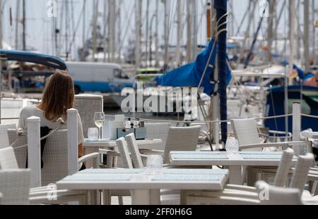 Palma, Espagne. 24 avril 2021. Une femme apprécie un verre de vin sur la terrasse d'un bar. Sur Majorque, de nouvelles relaxations de Corona s'appliquent depuis 24.04.2021. En fait, les restaurateurs sont autorisés à ouvrir les espaces extérieurs jusqu'à 5 h, les espaces intérieurs doivent rester fermés. Du lundi au jeudi, les établissements sont également autorisés à servir des clients sur les terrasses entre 20 h et 22 h 30. Credit: Clara Margais/dpa/Alay Live News Banque D'Images