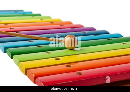 Instrument de musique xylophone avec barres en bois peintes en couleurs arc-en-ciel et maleta sur fond blanc isolé. Banque D'Images