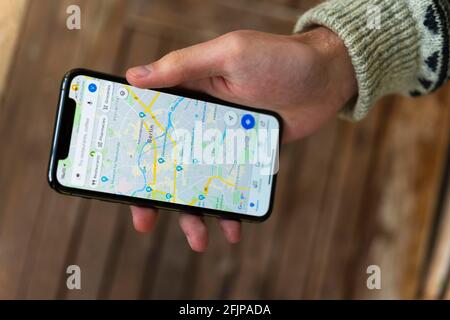 Hand haelt iPhone 11 Pro mit Google Maps App, Online Karten Dienst, Bildschirmfoto, smartphone Banque D'Images