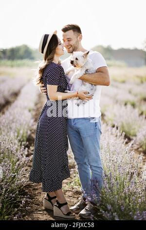 Couple amoureux avec chien dans le champ de lavande Banque D'Images