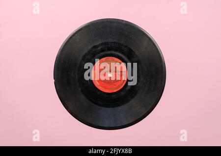 Ancien disque de vinyle soviétique des années 50 sur rose. Des médias rayés avec de la musique de l'URSS. La chanson 'Neighbor' a été interprétée par la chanson de l'armée soviétique et Dan Banque D'Images