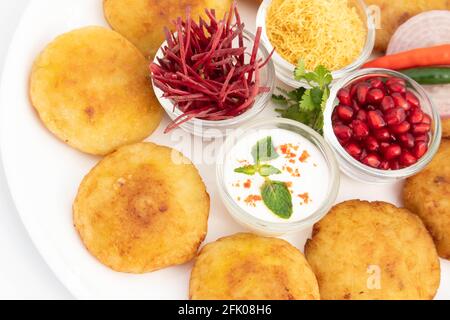 Délicieux en-cas Chaat Aloo Tikki également connu sous le nom d'Alu Ki Tikkia est une purée de pommes de terre cuite assaisonnée ou des viandes servies Avec Dahi Chat Masala Anar Sev Banque D'Images