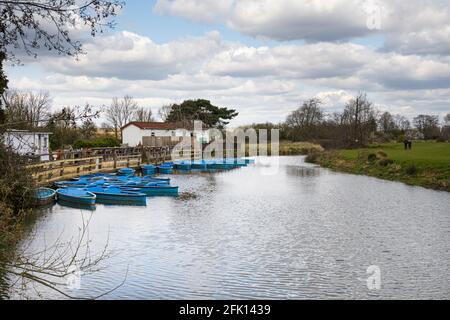 BARCOMBE MILLS, ANGLETERRE - 11 AVRIL : location de petits bateaux bleus sur l'Ouse, Sussex, Angleterre Banque D'Images