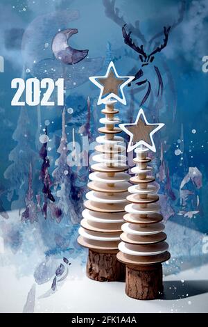 Carte de voeux design nouvel an 2021 avec décoration de Noël moderne sapins en bois et aquarelle éléments créatifs sur bleu. Banque D'Images