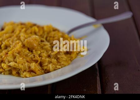 Risotto au poulet maison servi sur la plaque blanche. Riz italien servi en porcelaine. Plat typique de la cuisine brésilienne. Délicatesse culinaire. A fait maison Banque D'Images