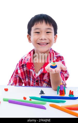 Petit garçon asiatique jouant et créant des jouets à partir de la pâte de jeu. Enfant souriant et montrer ses œuvres d'argile à la main, sur fond blanc. Renforcer l'im Banque D'Images