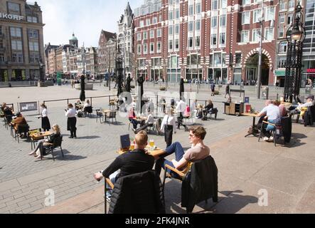 Amsterdam, pays-Bas. 28 avril 2021. Les membres du public apprécieront la terrasse d'un restaurant au Beursplein, dans le centre d'Amsterdam, au milieu de la pandémie du coronavirus, le 28 avril 2021 à Amsterdam, pays-Bas. Le gouvernement néerlandais prend aujourd'hui un pas important pour relâcher le blocage du coronavirus, après six mois de fermeture des terrasses et des magasins rouvrent mais ferment à 6 h à travers le pays. (Photo de Paulo Amorim/Sipa USA) Credit: SIPA USA/Alay Live News Banque D'Images