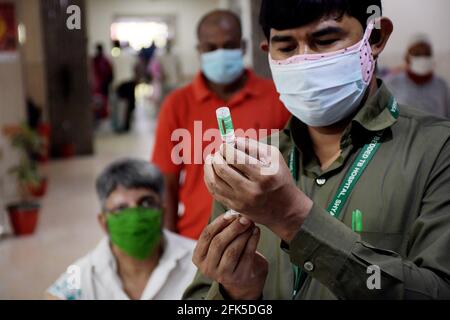 Dhaka, Bangladesh. 27 avril 2021. DHAKA, BANGLADESH - avril 28 : un personnel médical inocule un homme avec le vaccin contre le coronavirus Covid-19 à l'hôpital de 250 lits pour la tuberculose alors que la vaccination a commencé dans tout le pays le 28 avril 2021, à Dhaka, au Bangladesh.( Credit: SIPA USA/Alamy Live News Banque D'Images