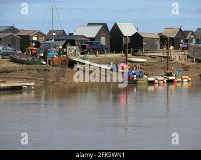 Vue depuis le côté Walberswick de la rivière Blyth jusqu'aux jetées et aux cabanes de pêcheurs noirs de Southwold Harbour. Banque D'Images