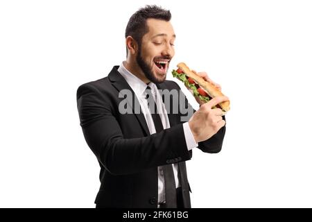 Jeune homme professionnel mangeant un sandwich dans une baguette isolée sur fond blanc Banque D'Images