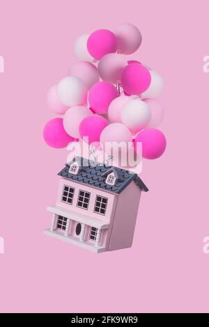 Idée créative avec une maison avec beaucoup de ballons colorés volant dans l'air. Concept minimal pour la publicité, le marketing ou la conception d'œuvres d'art. Banque D'Images