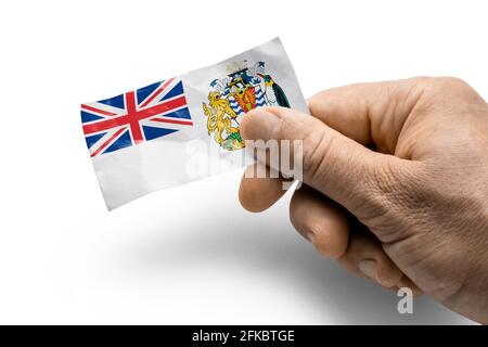 Main tenant une carte avec un drapeau national sur le territoire de l'Antarctique britannique Banque D'Images