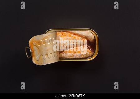 peut de sardines marinées sur fond noir Banque D'Images