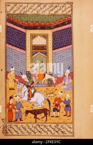 Peinture miniature Rajasthani du Rajasthan, Inde. Probablement à la fin du XIXe siècle ou au début du XXe siècle. Scène à l'extérieur d'un stable. Un homme mène un cheval Banque D'Images