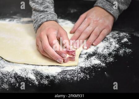 à la maison en quarantaine, nous cuisons et coupons les cookies avec emporte-pièces Banque D'Images