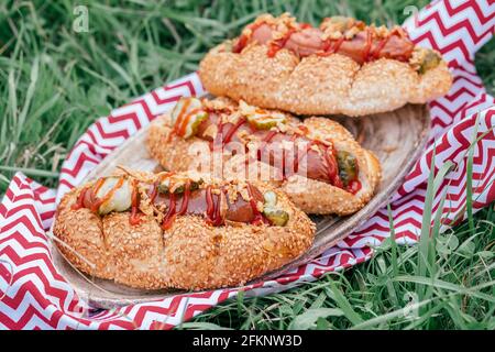 Hot-dogs grillés à la moutarde, ketchup et déguster sur une table de pique-nique Banque D'Images