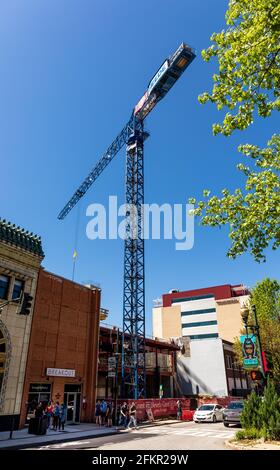 ASHEVILLE, NC, USA-1 MAI 2021: Construction sur la restauration de Patton, Paris Hôtel montre une grande grue, des gens sur le trottoir. Ensoleillé, jour de printemps. Banque D'Images