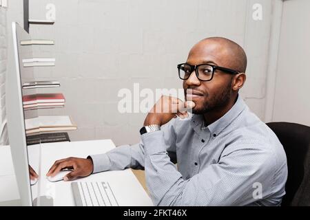 Portrait of young man using computer in design office Banque D'Images