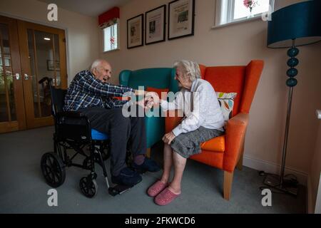 Un couple âgé de quatre-vingts a retrouvé un soin après avoir été séparé pendant plusieurs semaines en raison de la pandémie du coronavirus, Hampshire, Angleterre. Banque D'Images