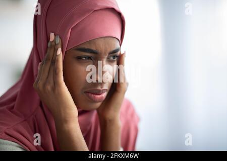 Concept de mal de tête. Gros plan de la femme musulmane noire dans le hijab souffrant de Migraine Banque D'Images