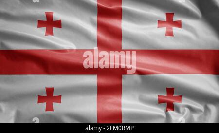 Drapeau géorgien agitant dans le vent. Gros plan de la bannière Georgia, soie douce et lisse. Tissu texture ensign arrière-plan. Banque D'Images