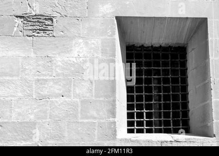 Fenêtre avec grille en fer forgé sur la façade en pierre de l'église Santa Maria à Elche, Alicante, Espagne Banque D'Images