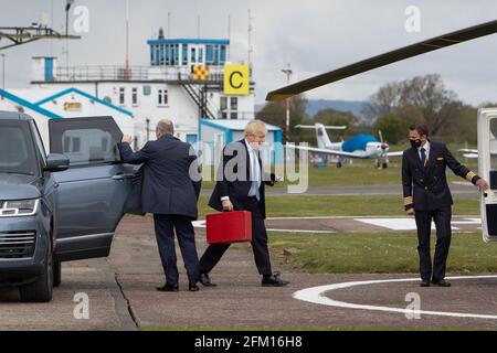 Aéroport de Wolverhampton Halfpenny Green, Royaume-Uni, 5 mai 2021. Le Premier ministre Boris Johnson monte à bord de son hélicoptère après une visite en vol dans le pays noir, le dernier jour de campagne en vue des élections du jeudi au Conseil local en Angleterre. Le premier ministre est revenu de Stourbridge où il s'était joint plus tôt au maire de West Midlands, Andy Street, pour une promenade en vélo sur le canal et a aidé à distribuer des dépliants de campagne. Credit: Paul Bunch / Alamy Live News. Banque D'Images