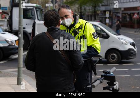 Berlin, Allemagne. 05e mai 2021. Un officier de l'équipe de police de vélo parle à un pilote de scooter électronique arrêté à Moabit pendant la campagne de sécurité routière inter-état 'sicher.mobil.leben'. À l'occasion de la campagne nationale de sécurité routière 'sicher.mobil.leben' (safe.mobile.living), la police vérifie de plus en plus les passagers à deux roues dans la circulation routière. Credit: Paul Zinken/dpa-Zentralbild/dpa/Alay Live News Banque D'Images