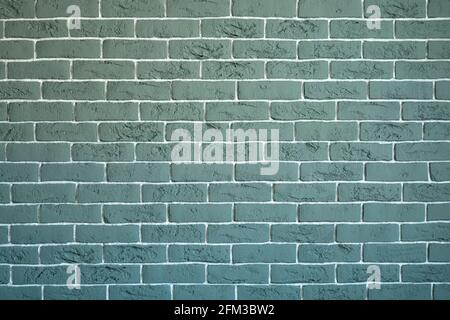 Le mur de briques est gris-vert avec une jonction blanche. Arrière-plan vintage créatif Banque D'Images