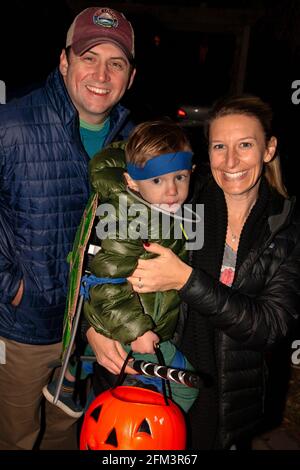 Halloween trick and treater avec costume de guerrier et une citrouille avec maman et papa. St Paul Minnesota MN États-Unis Banque D'Images