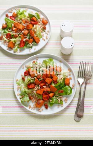 Salade de patates douces avec tomates rôties, laitue et romarin noix de pécan Banque D'Images