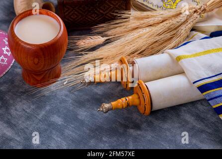 Torah et tallis dans la fête traditionnelle de la saison des fêtes juives Shavuot sur la nourriture de crèmerie de casher Banque D'Images